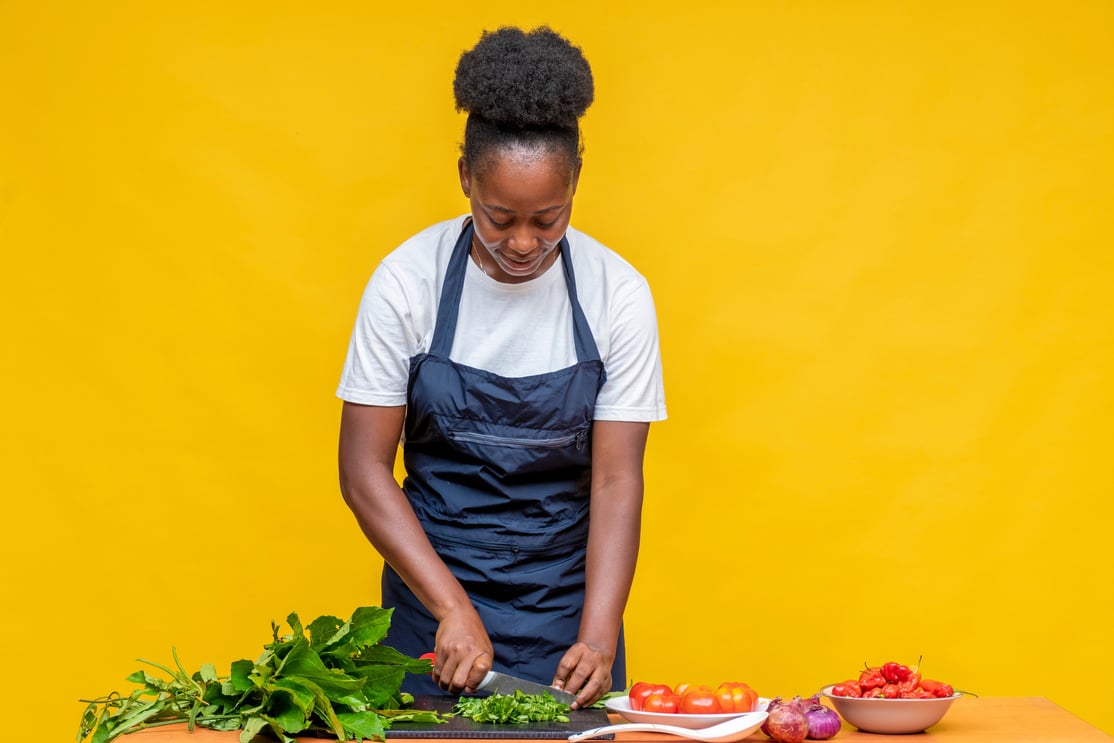 african lady chef chopping some vegetable