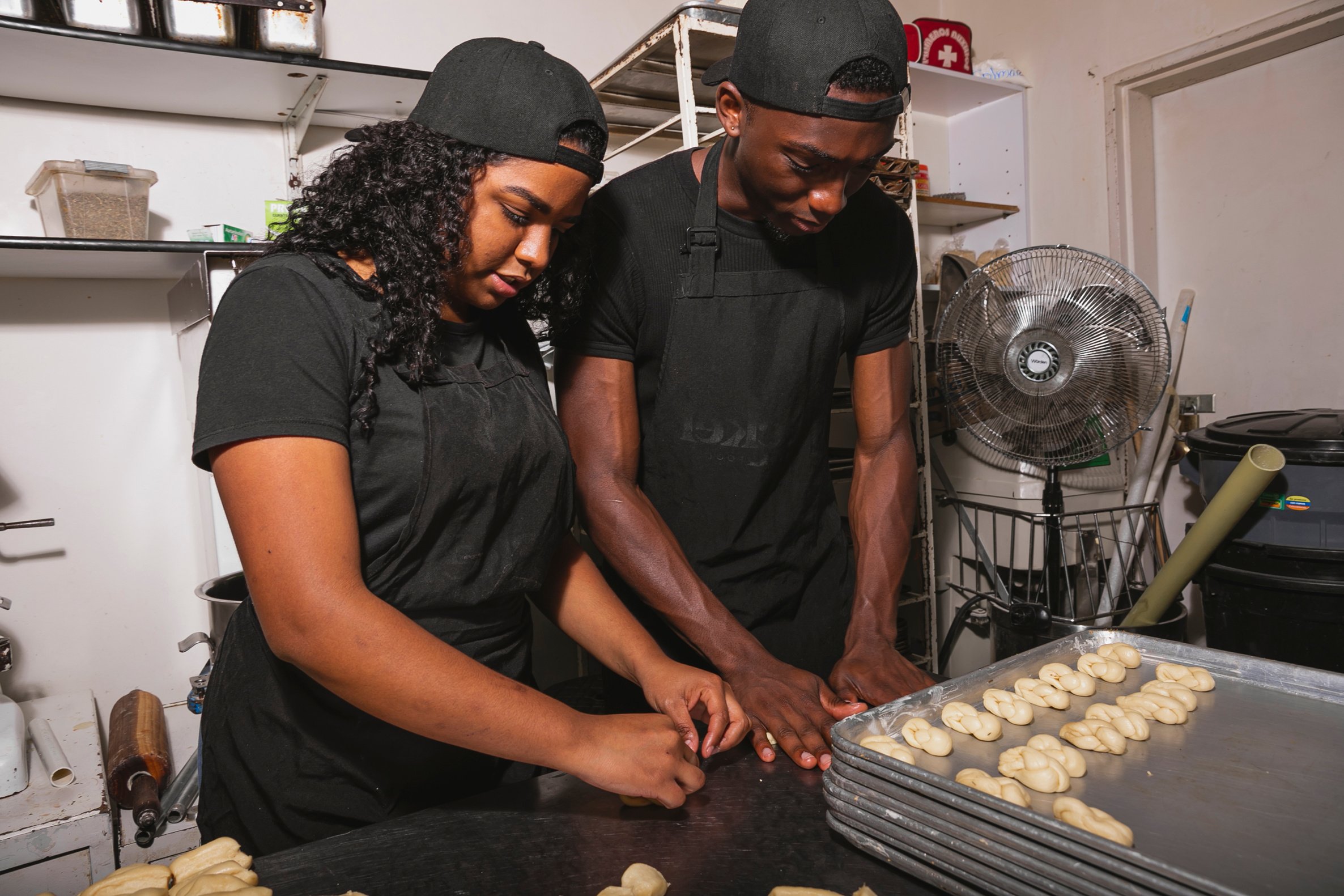 Male and Female Bakers Baking Bread Together